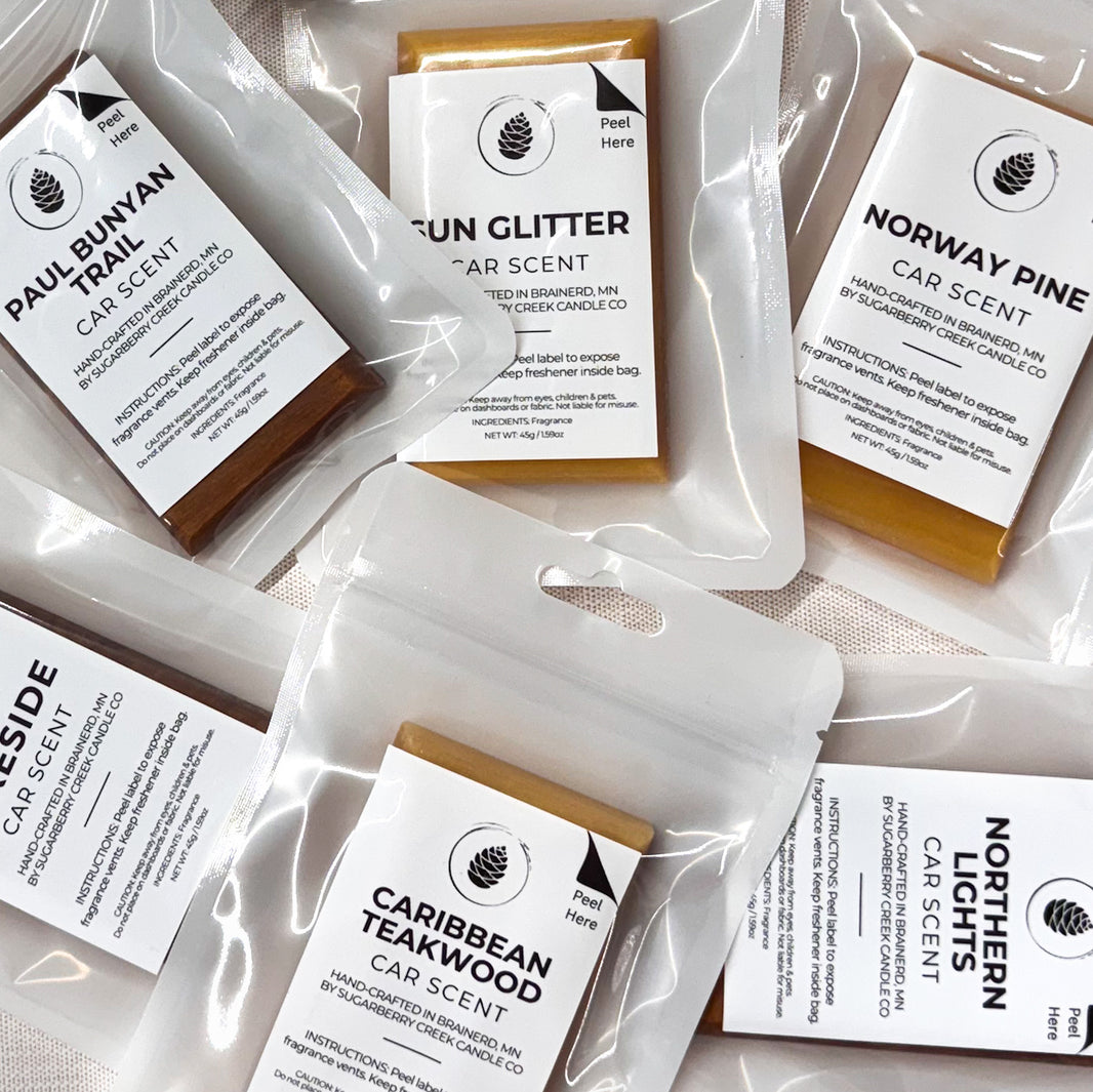 Collection of car scent packets with labels on a light background