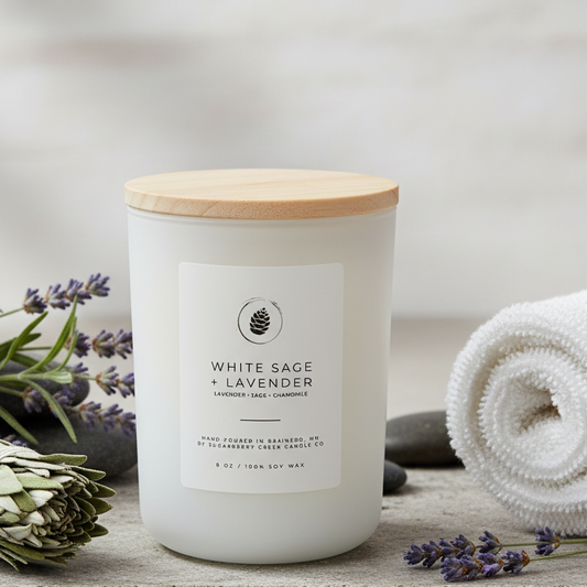 White sage and lavender candle with a wooden surrounded by lavender and sage