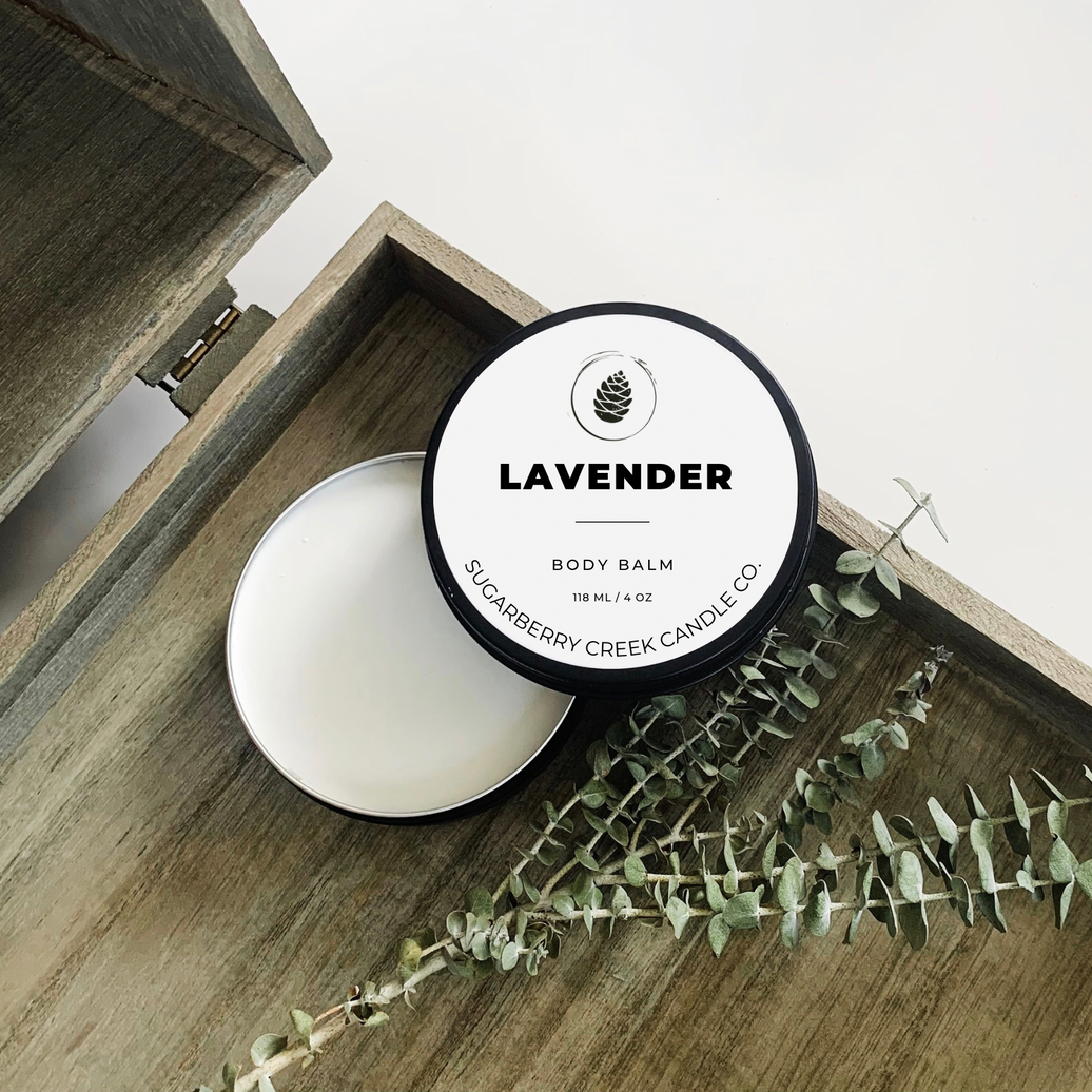 Lavender body balm tin on a wooden tray with sage twigs