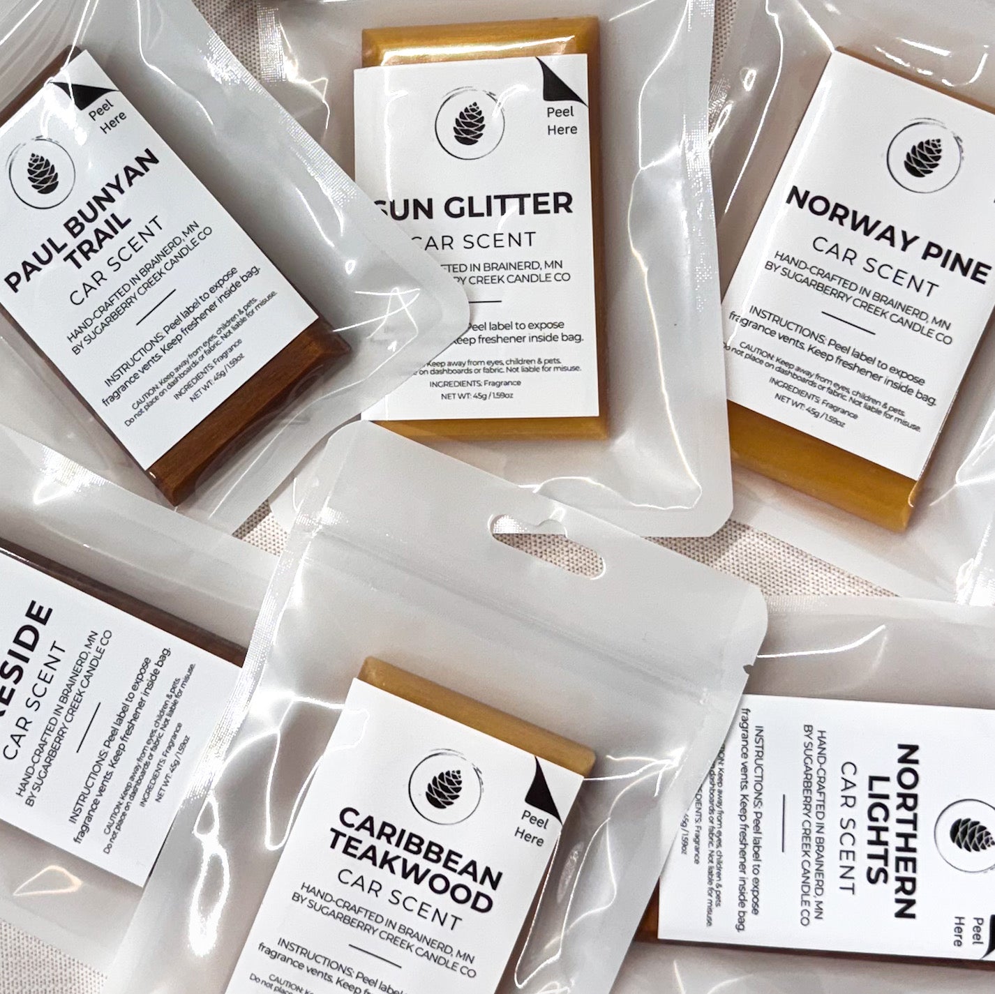 Collection of car scent packets with labels on a light background