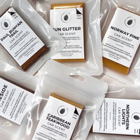 Collection of car scent packets with labels on a light background