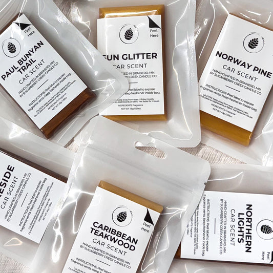 Collection of car scent packets with labels on a light background