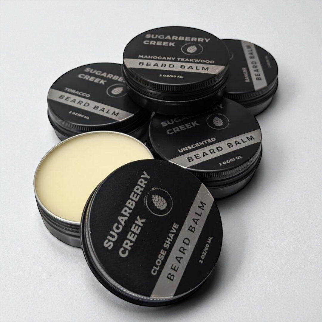 Collection of Sugarberry Creek beard balm containers on a white background