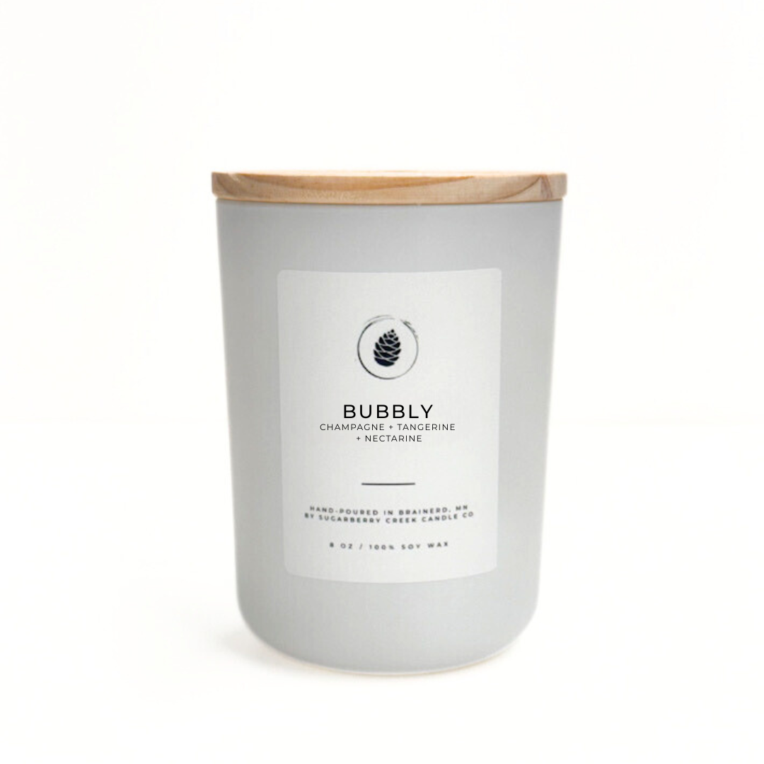 Candle with a wooden lid and label on a white background