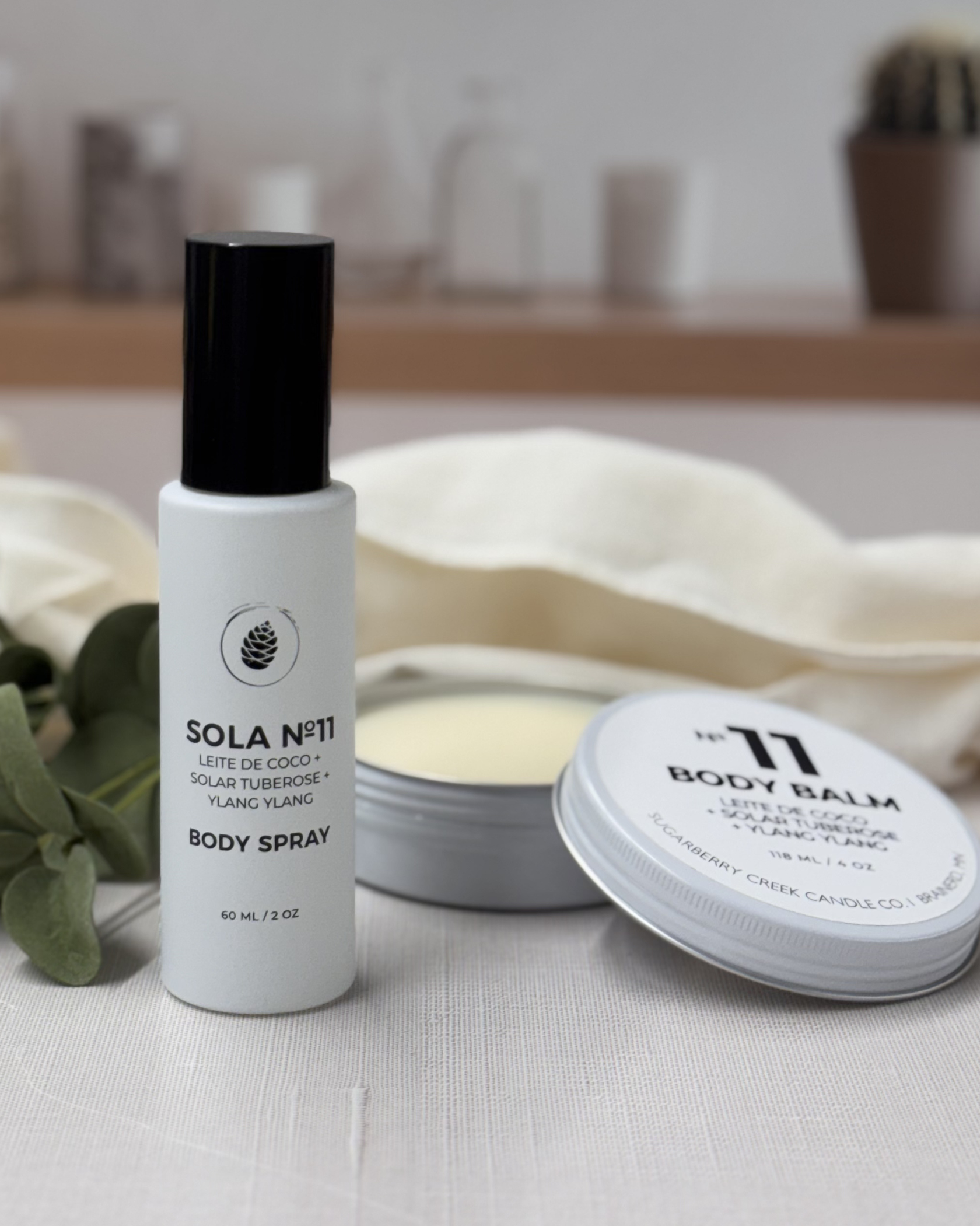 Body spray and balm with 'Sola No. 11' branding on a neutral background