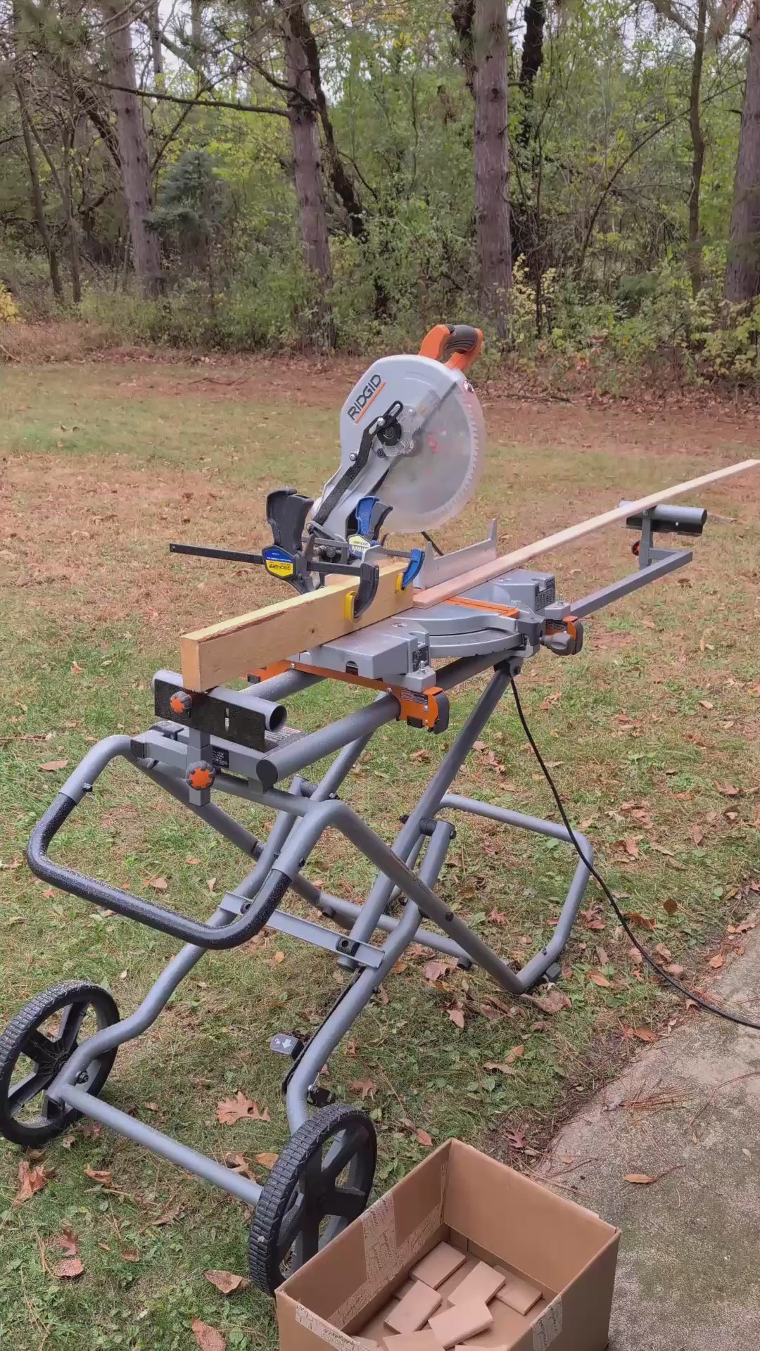 Man in green and black plaid shirt cutting wood into blocks and routing the edges.
