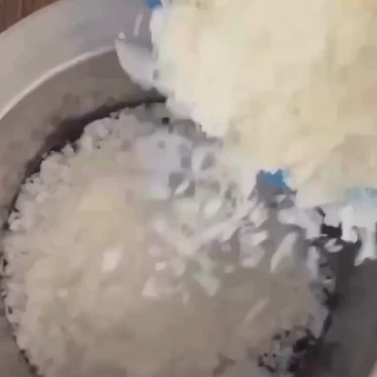 pouring soy was into wax melter and pouring melted wax into candle jars